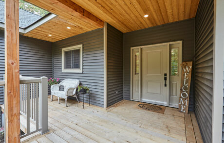 Muskoka Lakes enclosed porch entrance way with timber beams and exterior potlights
